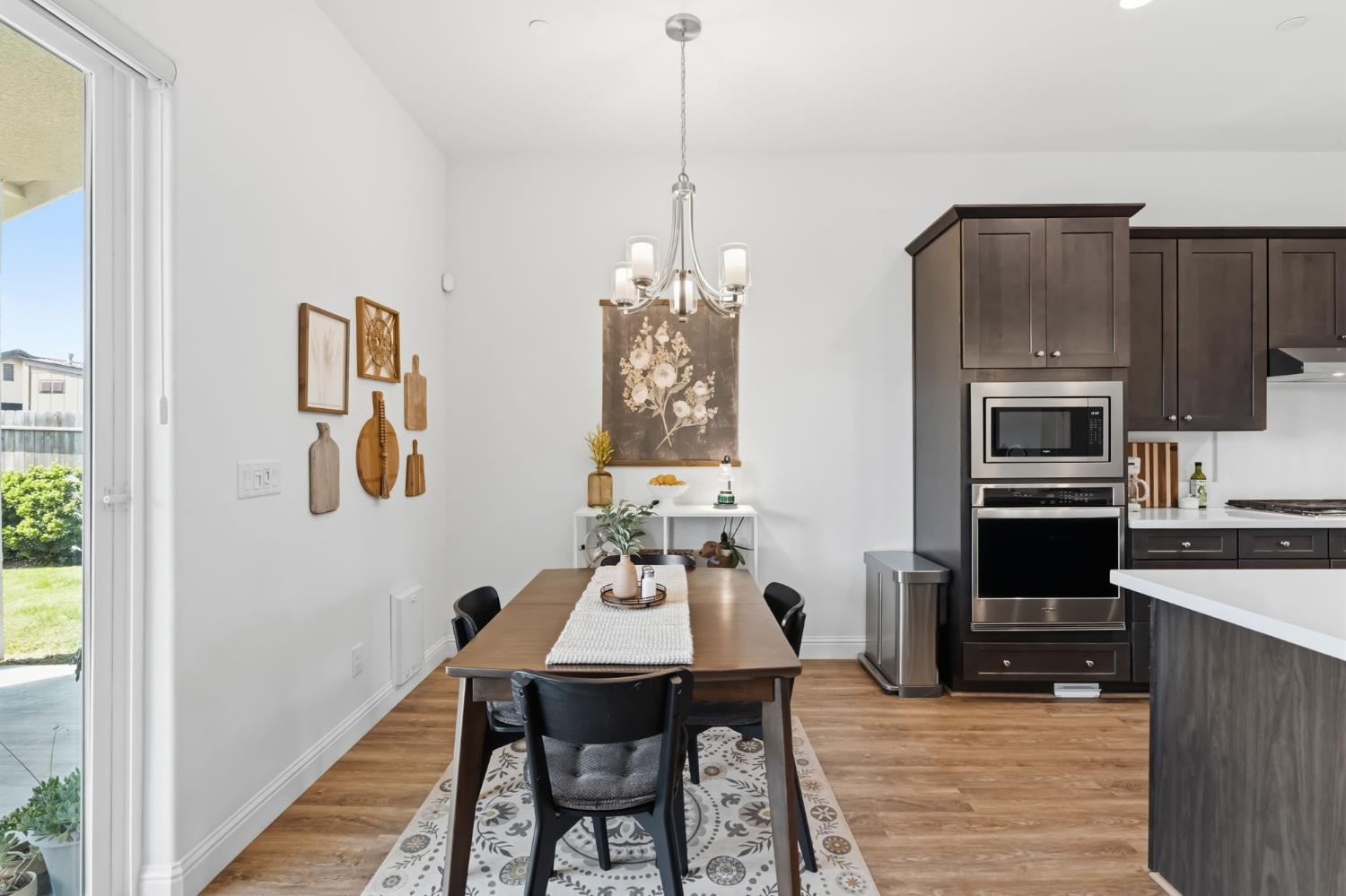 2100 Azalea Street Kingsburg, CA 93631 - Photo 15 of 54 a view of a dining room with furniture wooden floor and a chandelier