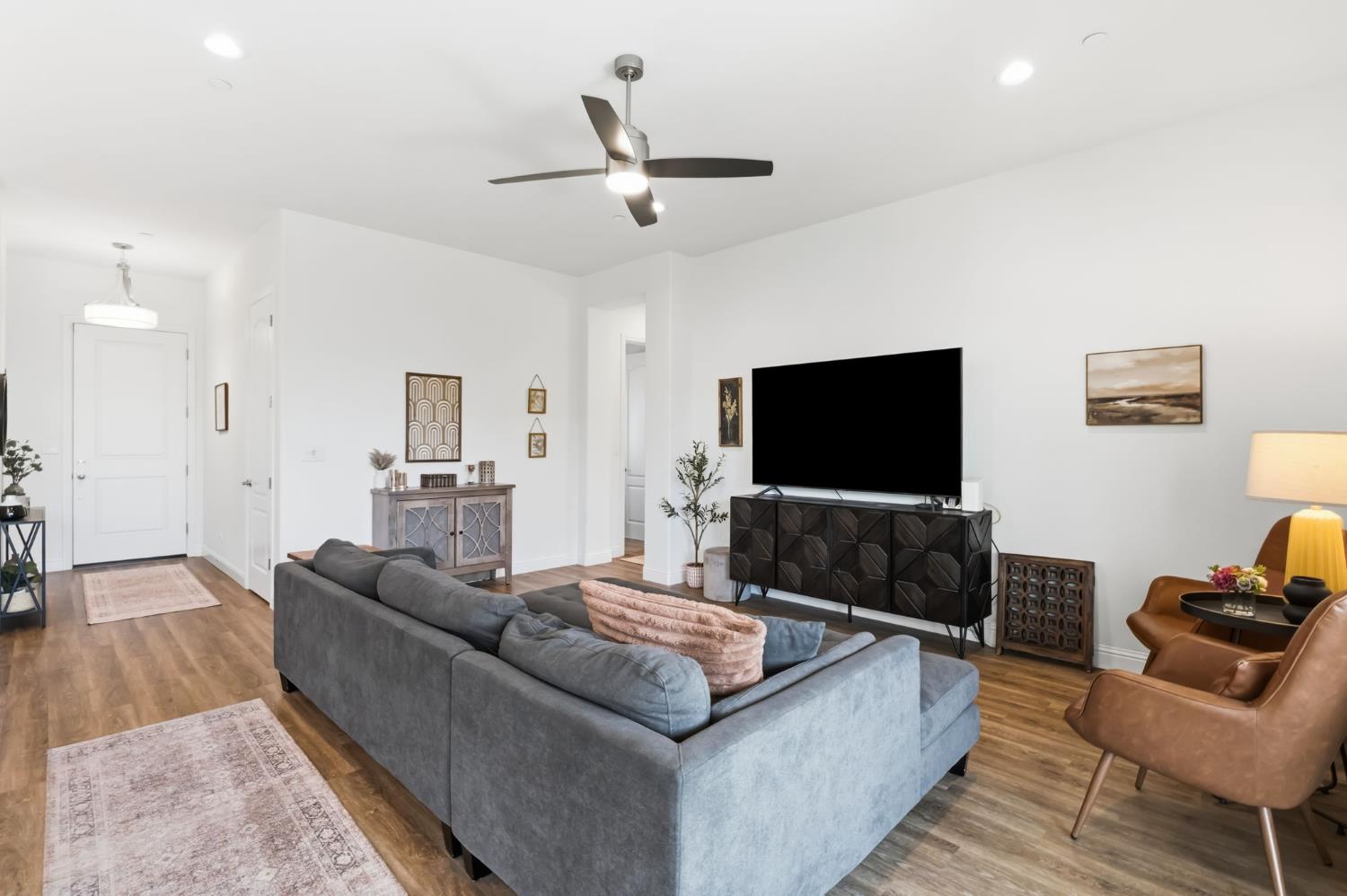 2100 Azalea Street Kingsburg, CA 93631 - Photo 17 of 54 a living room with furniture and a flat screen tv