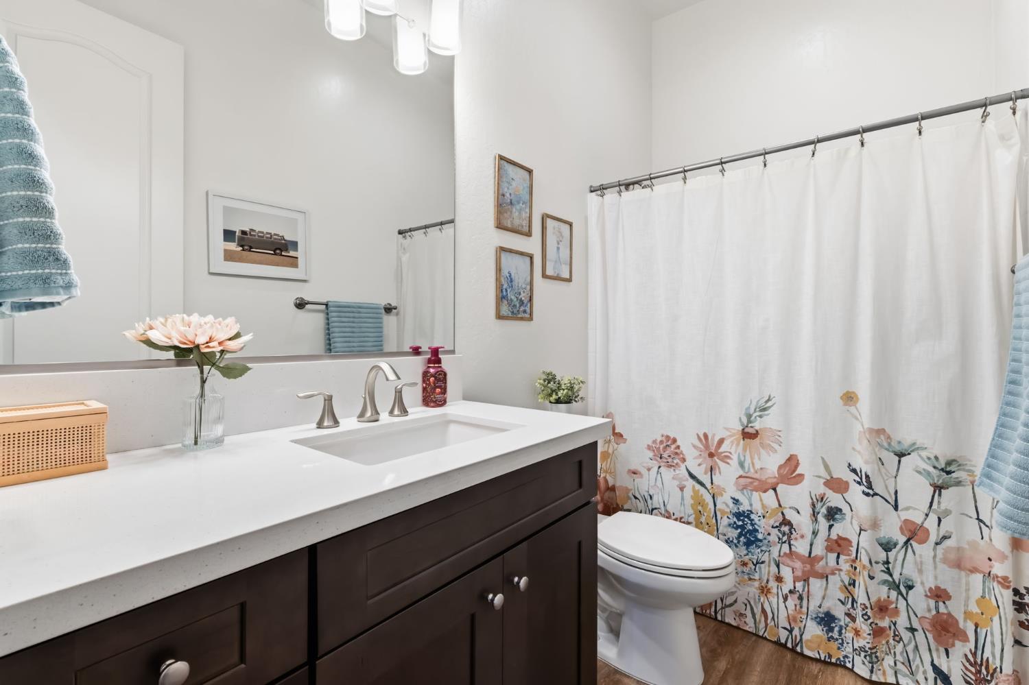 2100 Azalea Street Kingsburg, CA 93631 - Photo 21 of 54 a bathroom with a sink a toilet and mirror