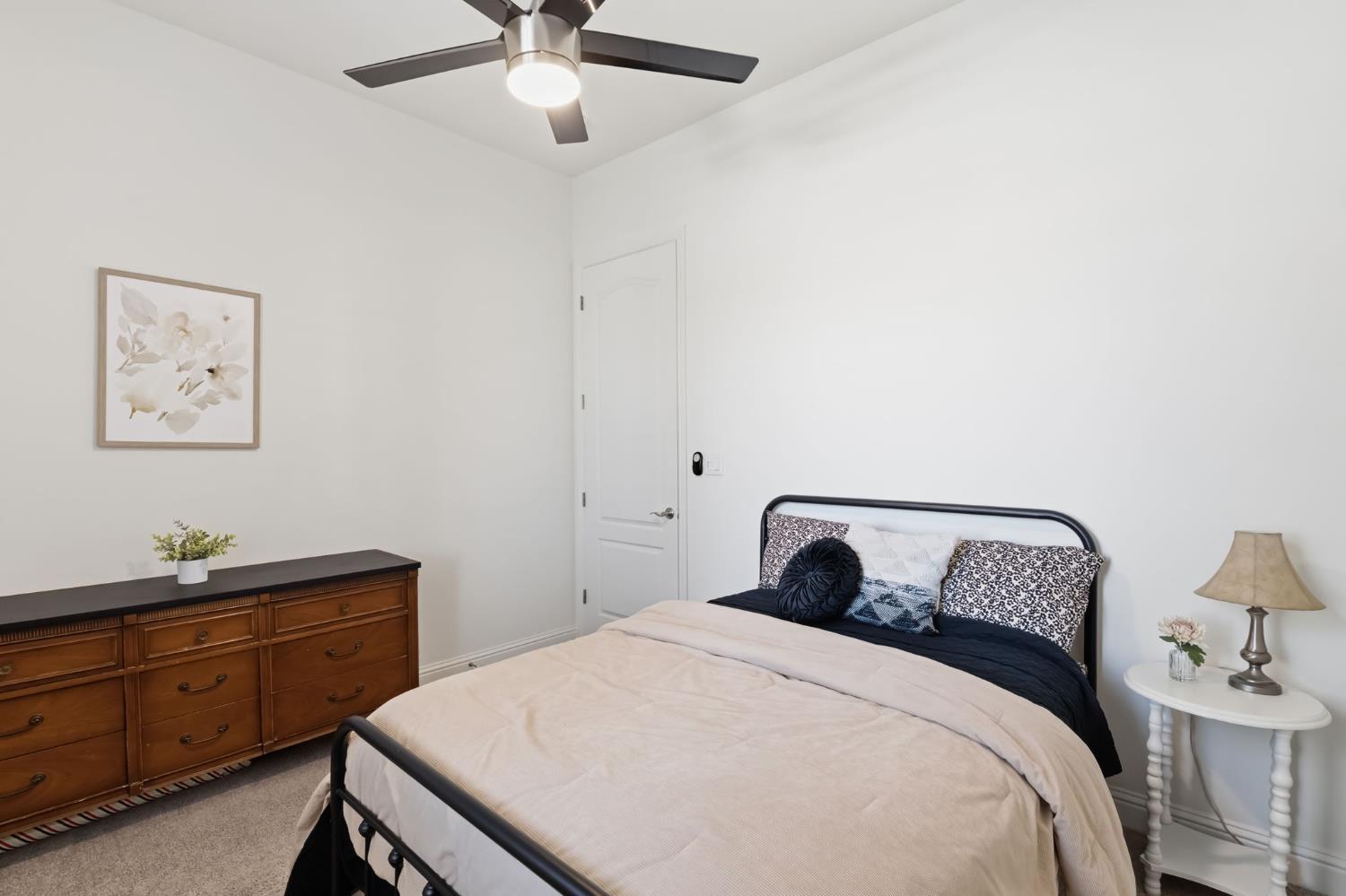 2100 Azalea Street Kingsburg, CA 93631 - Photo 23 of 54 a bedroom with a bed and a lamp on dresser