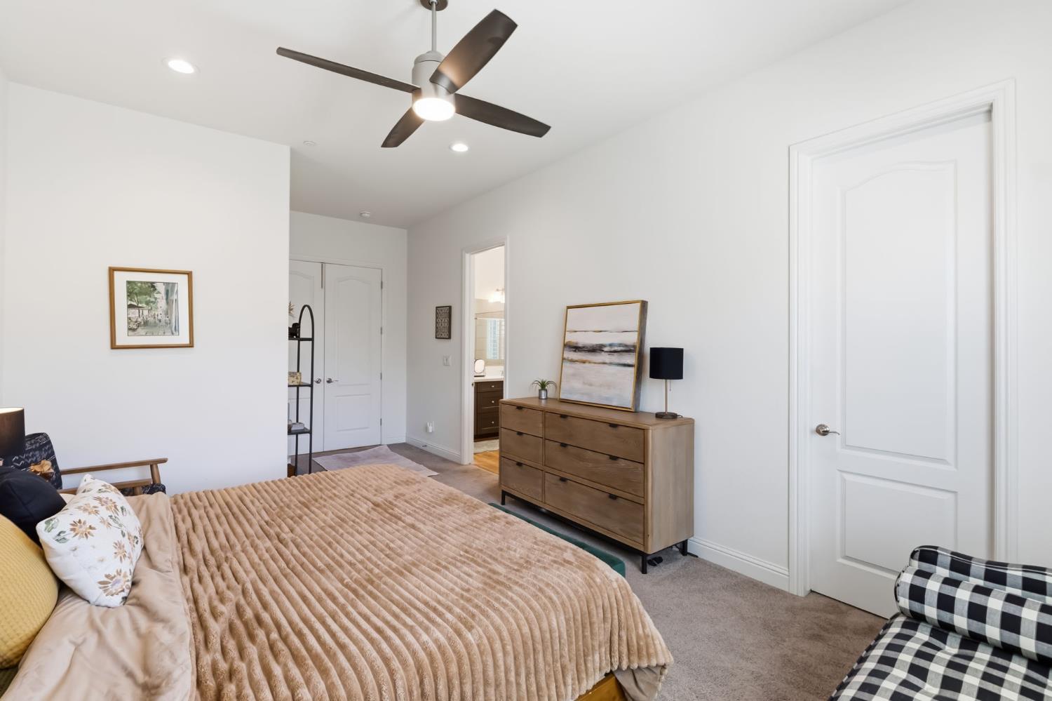 2100 Azalea Street Kingsburg, CA 93631 - Photo 28 of 54 a bedroom with a bed and a lamp on a dresser