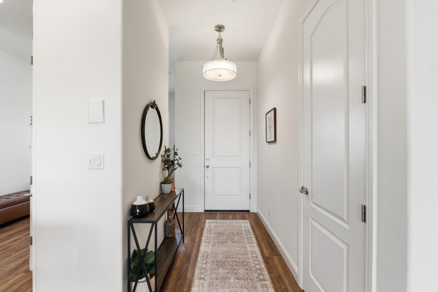 2100 Azalea Street Kingsburg, CA 93631 - Photo 8 of 54 a view of a hallway with wooden floor and staircase