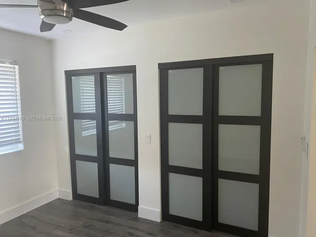 a room with a large window and bed