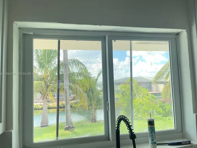 a view of an empty room with wooden floor and closet
