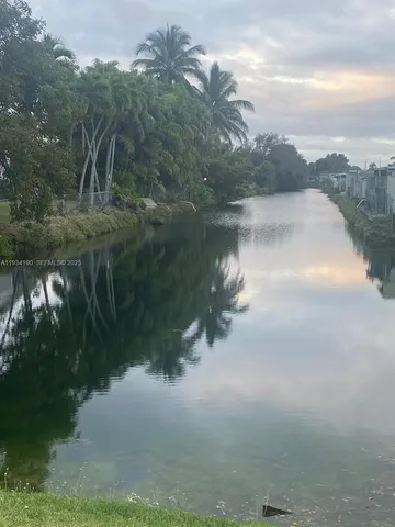 a view of a kitchen with white cabinets