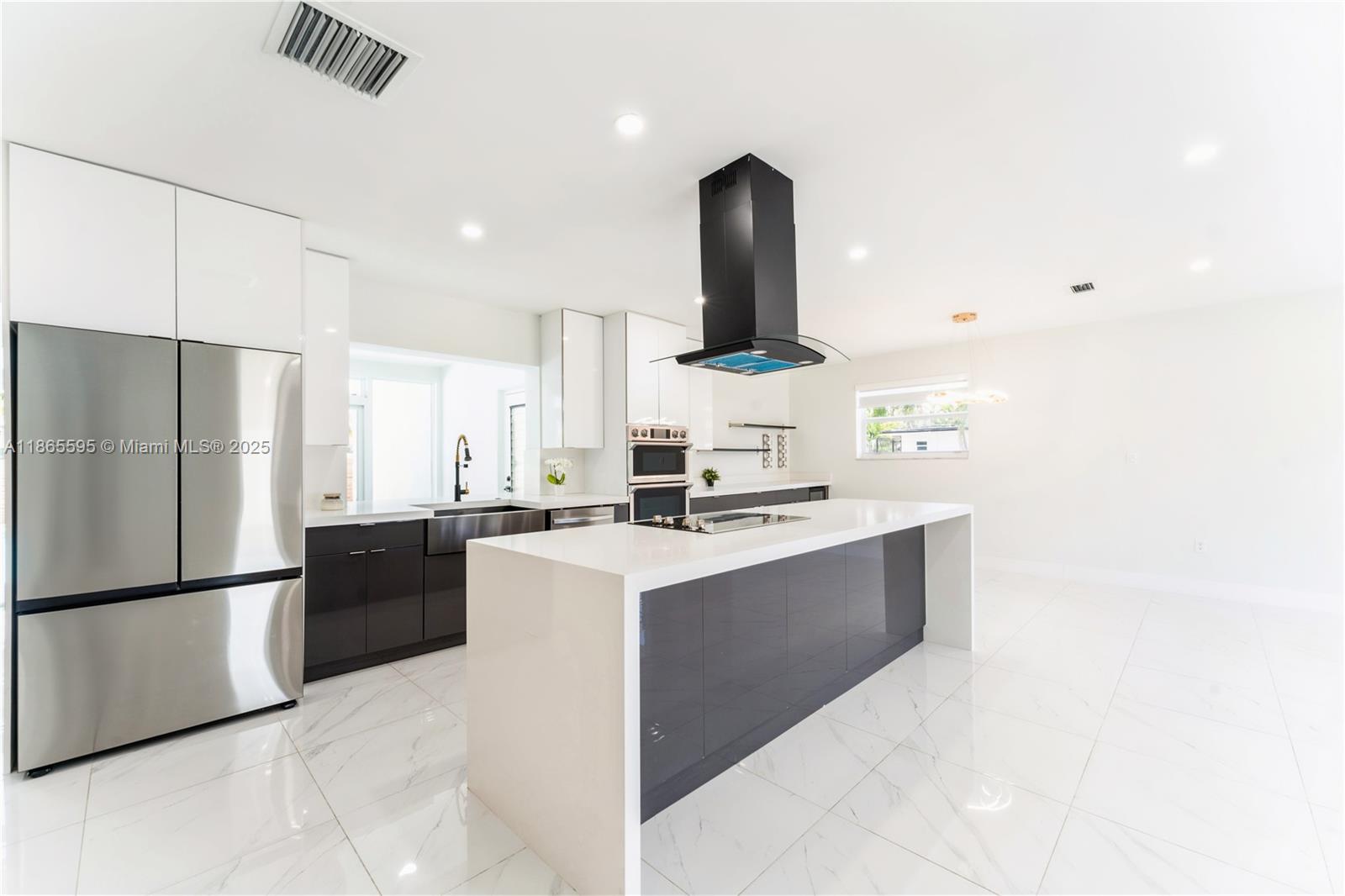 1446 Scott Street Hollywood, FL 33020 - Photo 14 of 47 a kitchen with stainless steel appliances kitchen island a sink stove and refrigerator