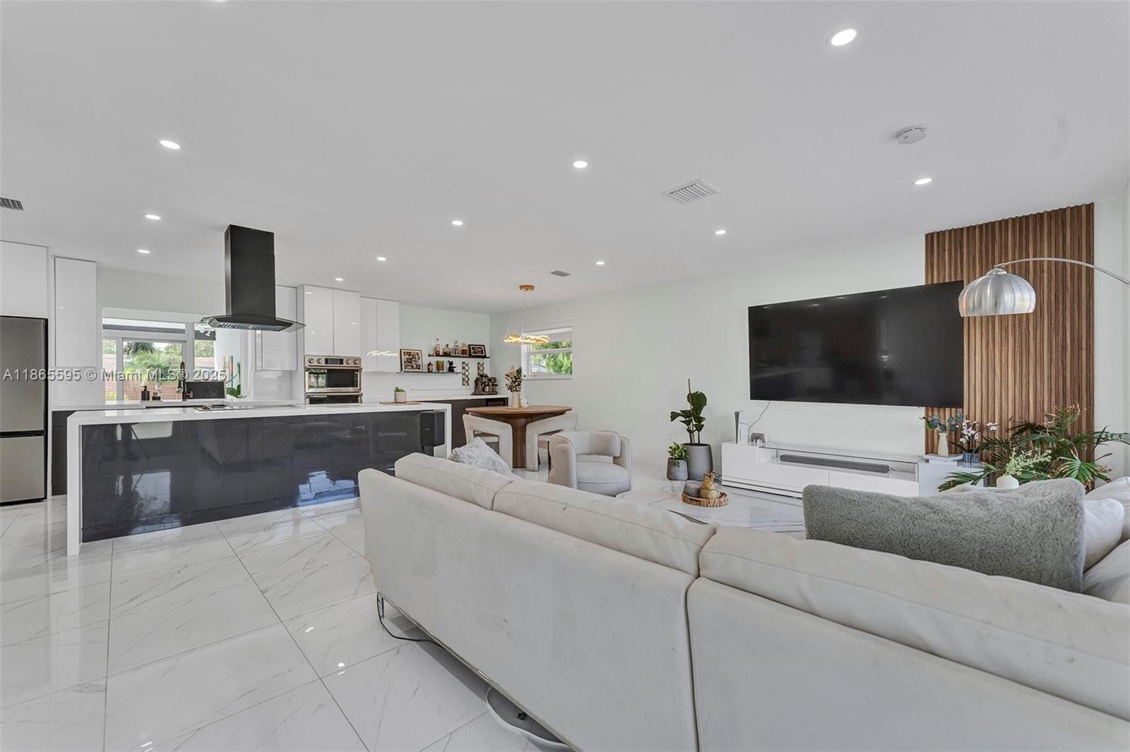 1446 Scott Street Hollywood, FL 33020 - Photo 17 of 47 a living room with furniture and a flat screen tv