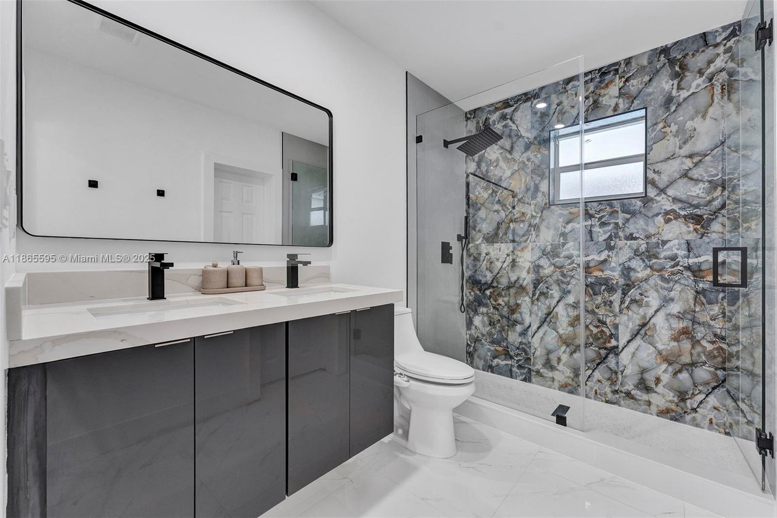 1446 Scott Street Hollywood, FL 33020 - Photo 22 of 47 a bathroom with a sink and a mirror