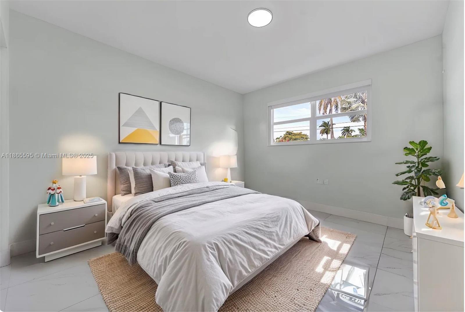 1446 Scott Street Hollywood, FL 33020 - Photo 27 of 47 a bedroom with a bed and a potted plant