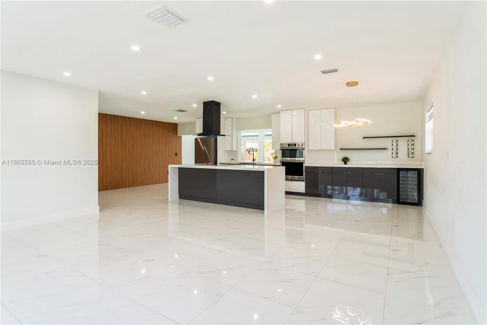 1446 Scott Street Hollywood, FL 33020 - Photo 3 of 47 a large kitchen with stainless steel appliances a large counter top a stove and a sink