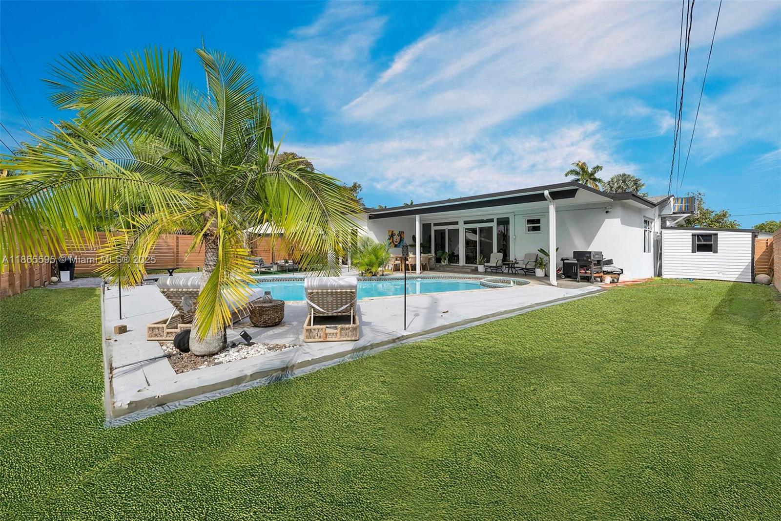 1446 Scott Street Hollywood, FL 33020 - Photo 36 of 47 a view of a patio with table and chairs potted plants and palm tree