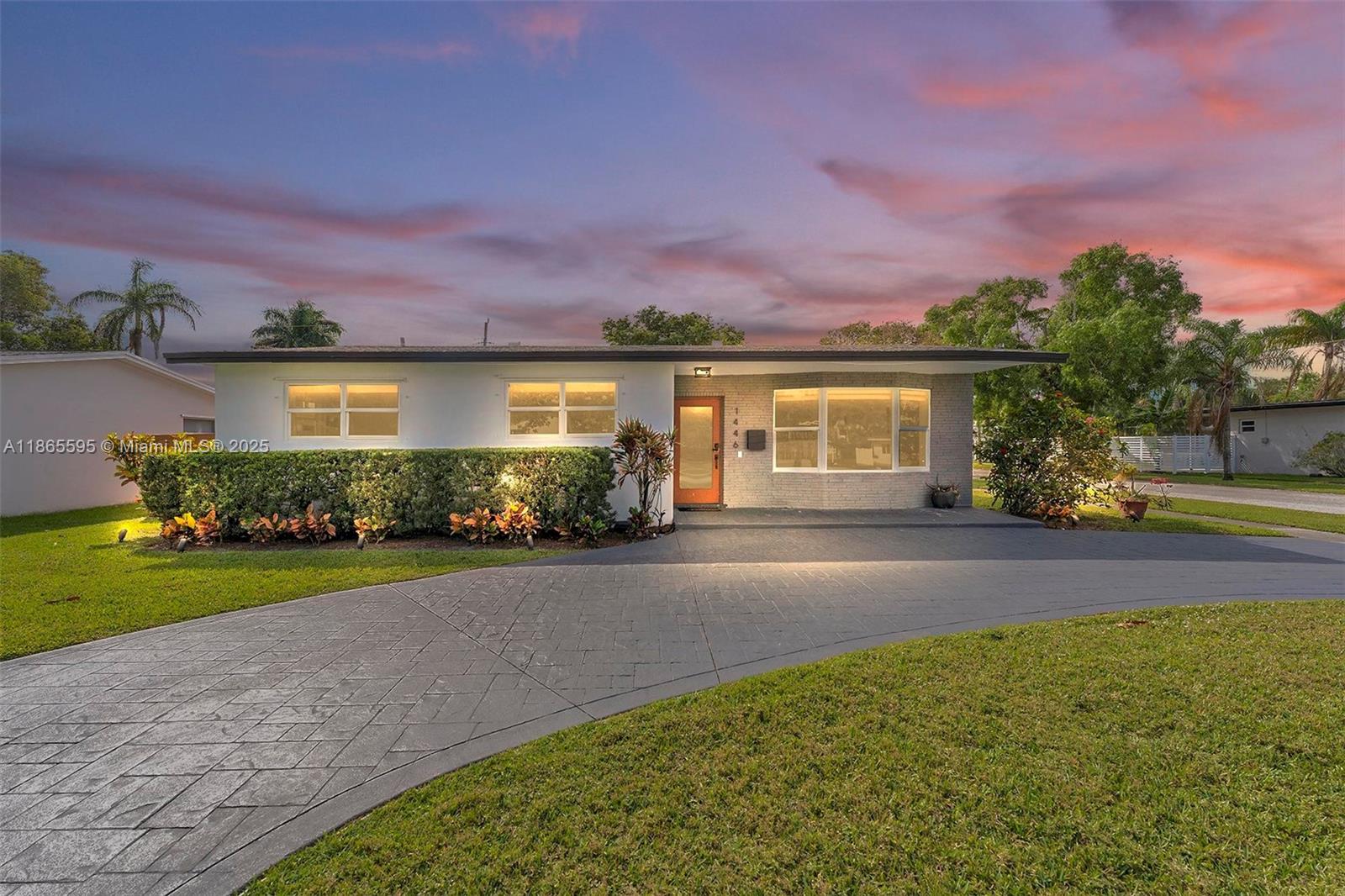 1446 Scott Street Hollywood, FL 33020 - Photo 42 of 47 a front view of a house with a yard and garage