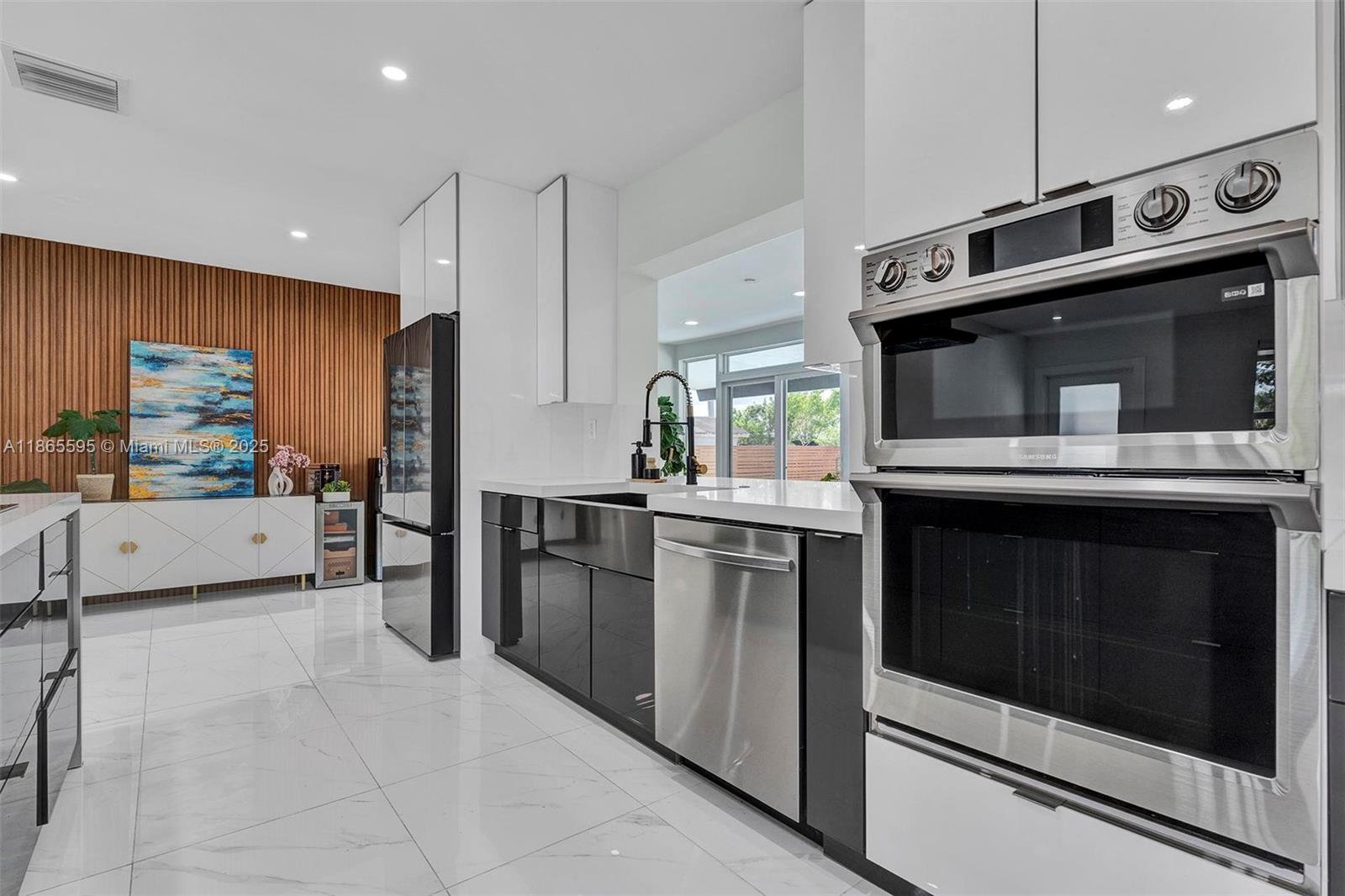 1446 Scott Street Hollywood, FL 33020 - Photo 5 of 47 a kitchen with stainless steel appliances kitchen island granite countertop a stove and a microwave