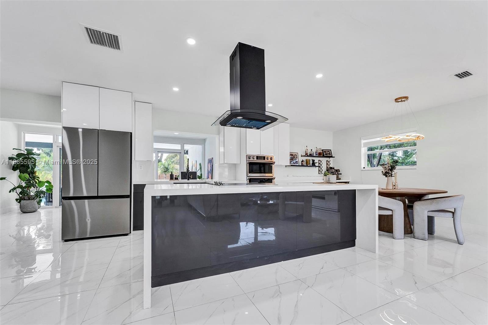1446 Scott Street Hollywood, FL 33020 - Photo 6 of 47 a kitchen with stainless steel appliances kitchen island granite countertop a refrigerator and a stove top oven