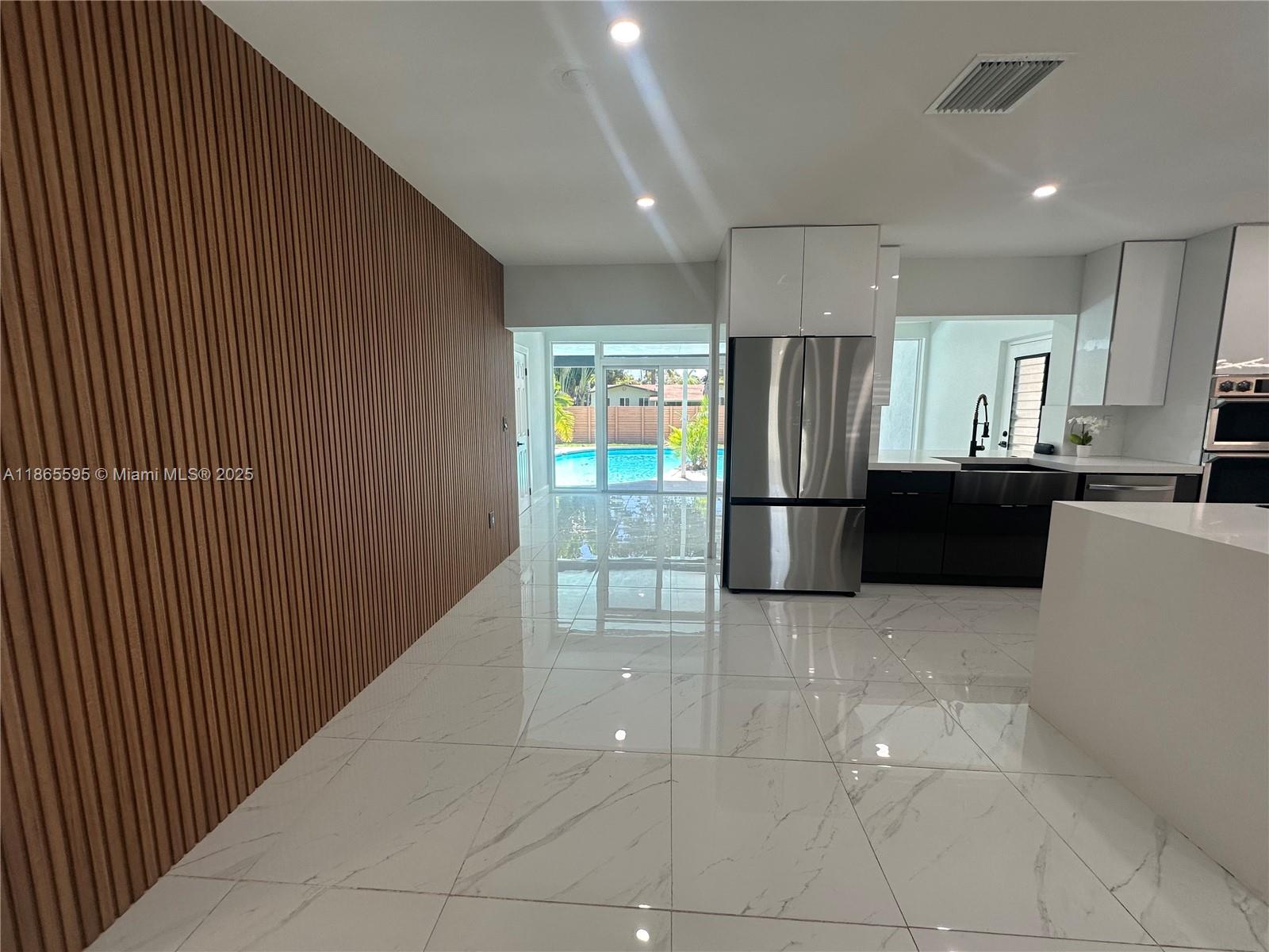1446 Scott Street Hollywood, FL 33020 - Photo 8 of 47 a kitchen with stainless steel appliances granite countertop a refrigerator and a sink