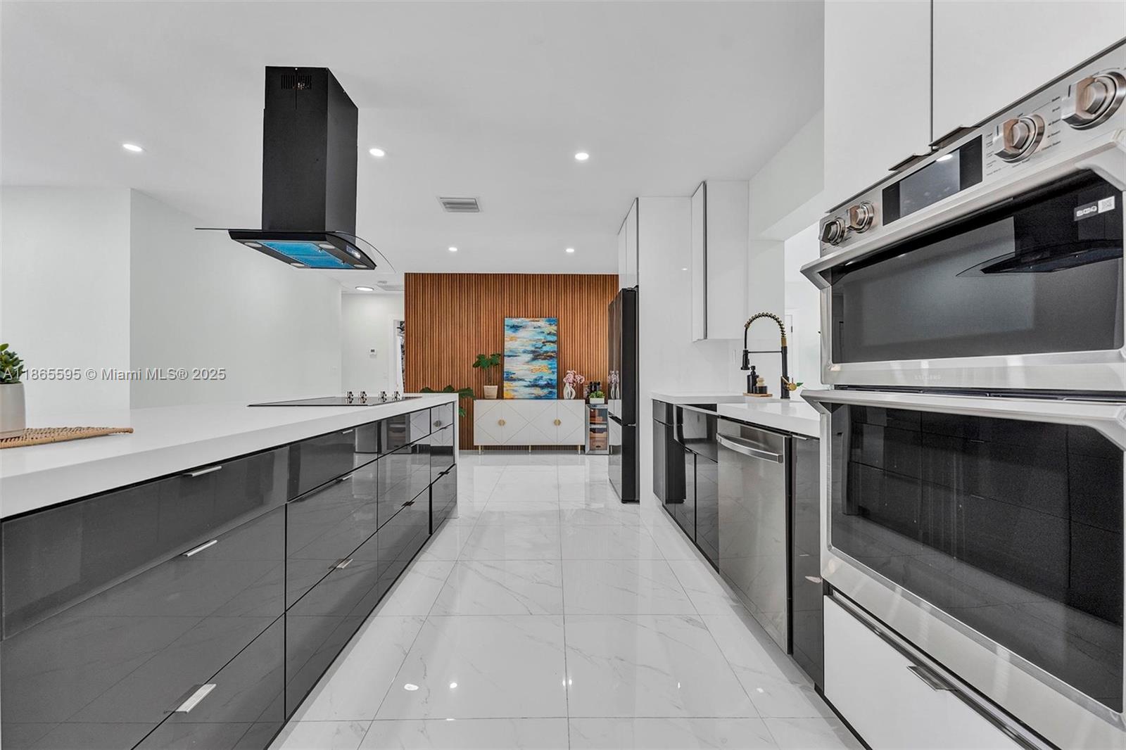 1446 Scott Street Hollywood, FL 33020 - Photo 9 of 47 a large kitchen with stainless steel appliances kitchen island granite countertop a stove a sink and a microwave