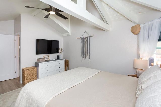 a spacious bathroom with a granite countertop sink mirror and a bathtub