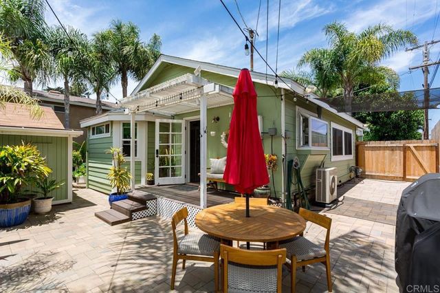 a patio with glass top table and chairs