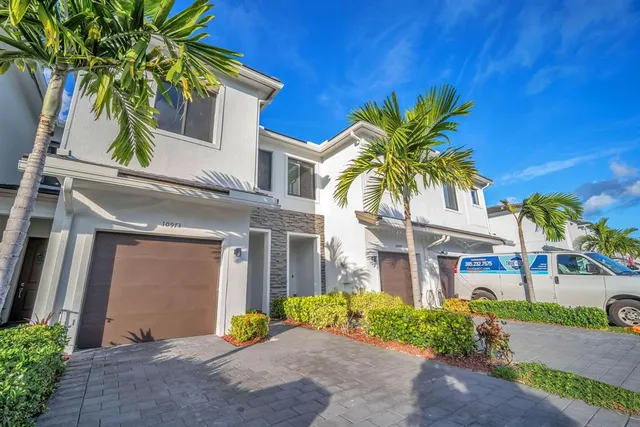 a bathroom with a granite countertop toilet a sink and a mirror