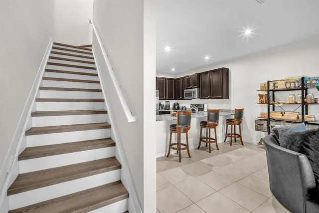 a view of a house with backyard and wooden fence
