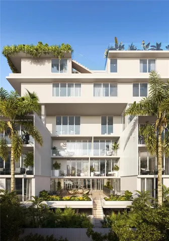 a front view of a building with a garden