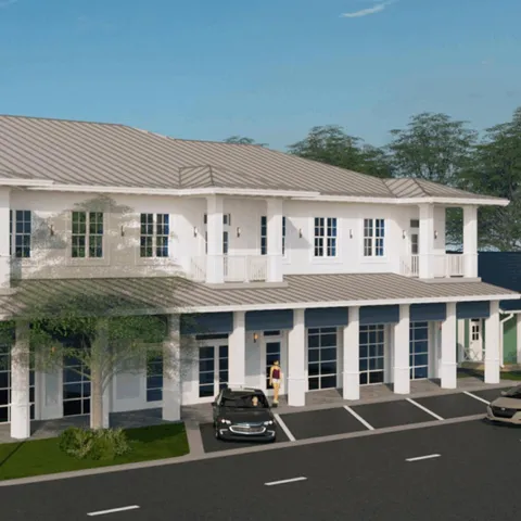 a front view of a residential apartment building with a yard