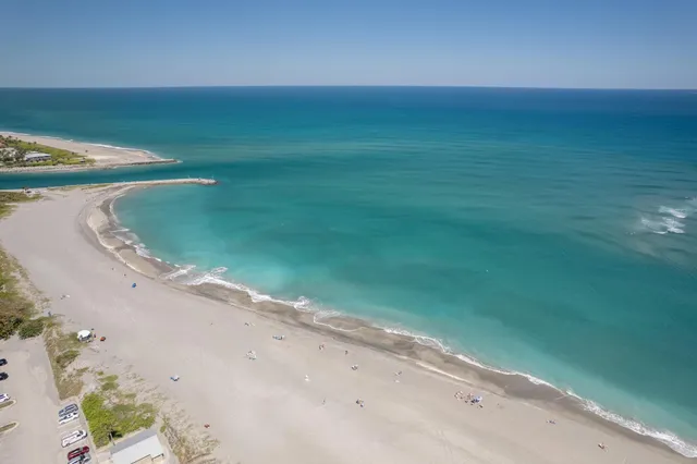 a view of a swimming pool with a patio and a yard