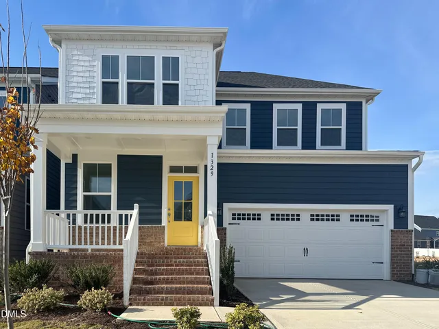 a view of a house with wooden fence