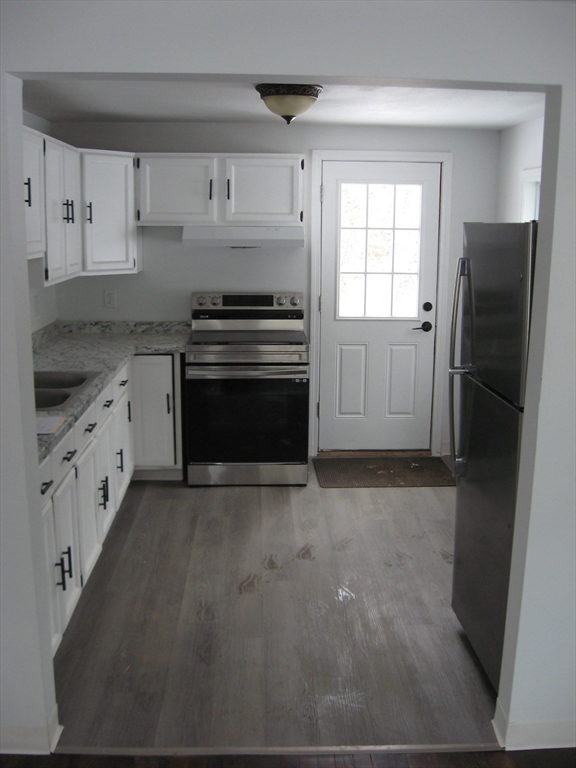 160 Peterson Road Palmer, MA 01069 - Photo 12 of 24 a kitchen with granite countertop a refrigerator stove and white cabinets