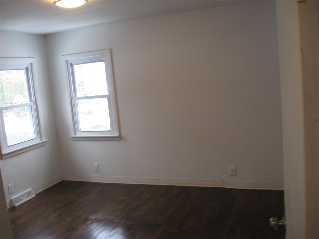 160 Peterson Road Palmer, MA 01069 - Photo 14 of 24 an empty room with wooden floor and windows