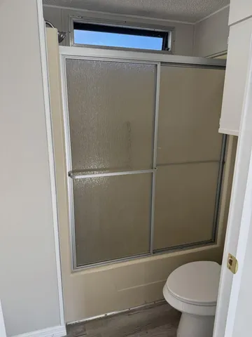 a bathroom with a shower and a toilet