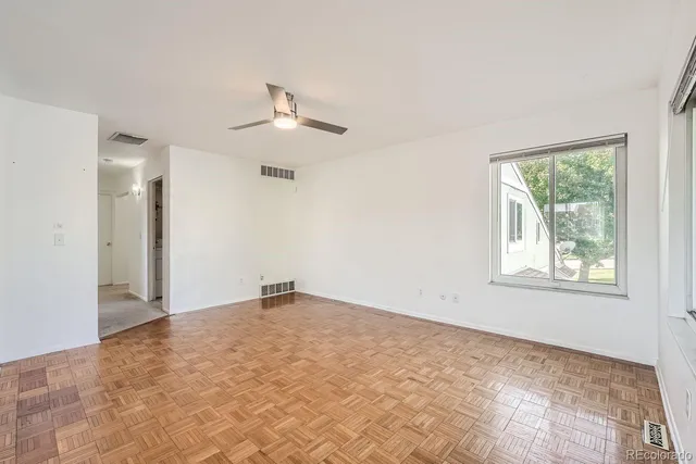an empty room with windows and closet