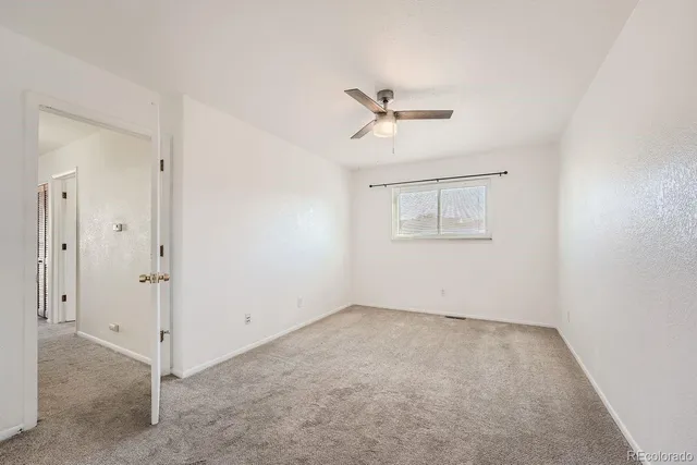 a view of room with window and ceiling fan