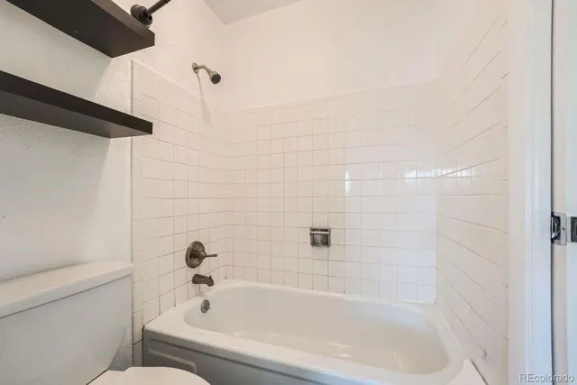 a bathroom with a bathtub and a toilet