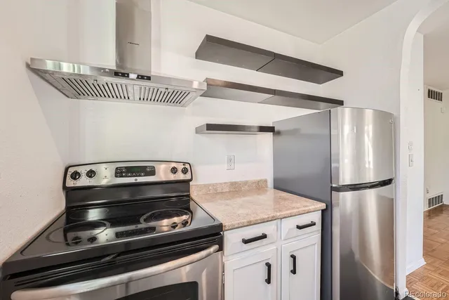 a stove top oven sitting inside of a kitchen
