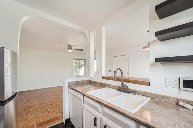a kitchen with a sink and a refrigerator