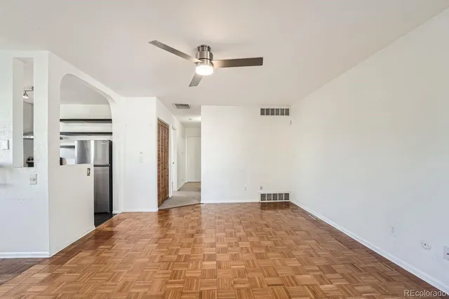 a view of a big room with closet and windows