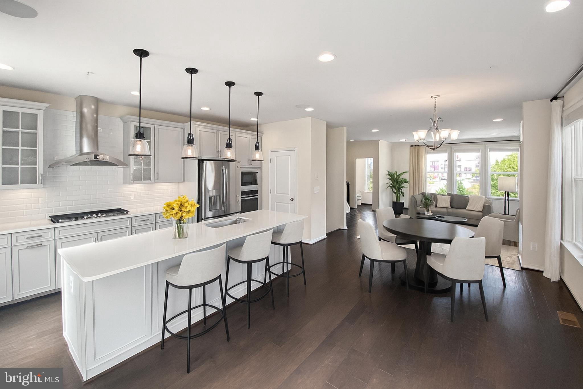 4967 Lakeside Crossing Chantilly, VA 20151 - Photo 16 of 45 a kitchen with stainless steel appliances kitchen island granite countertop a table chairs and a stove