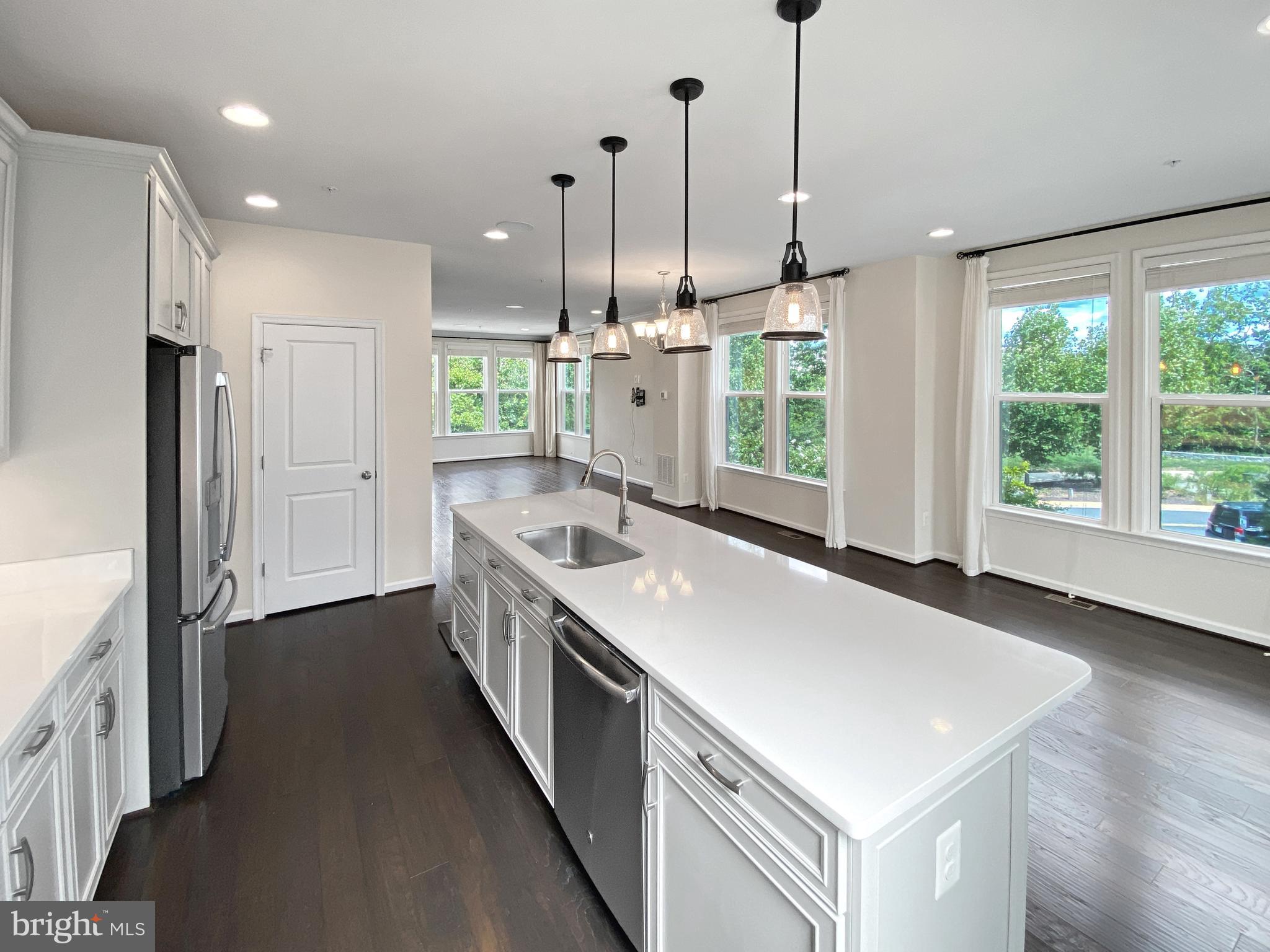4967 Lakeside Crossing Chantilly, VA 20151 - Photo 19 of 45 a kitchen with a stove a sink a refrigerator and a wooden floor