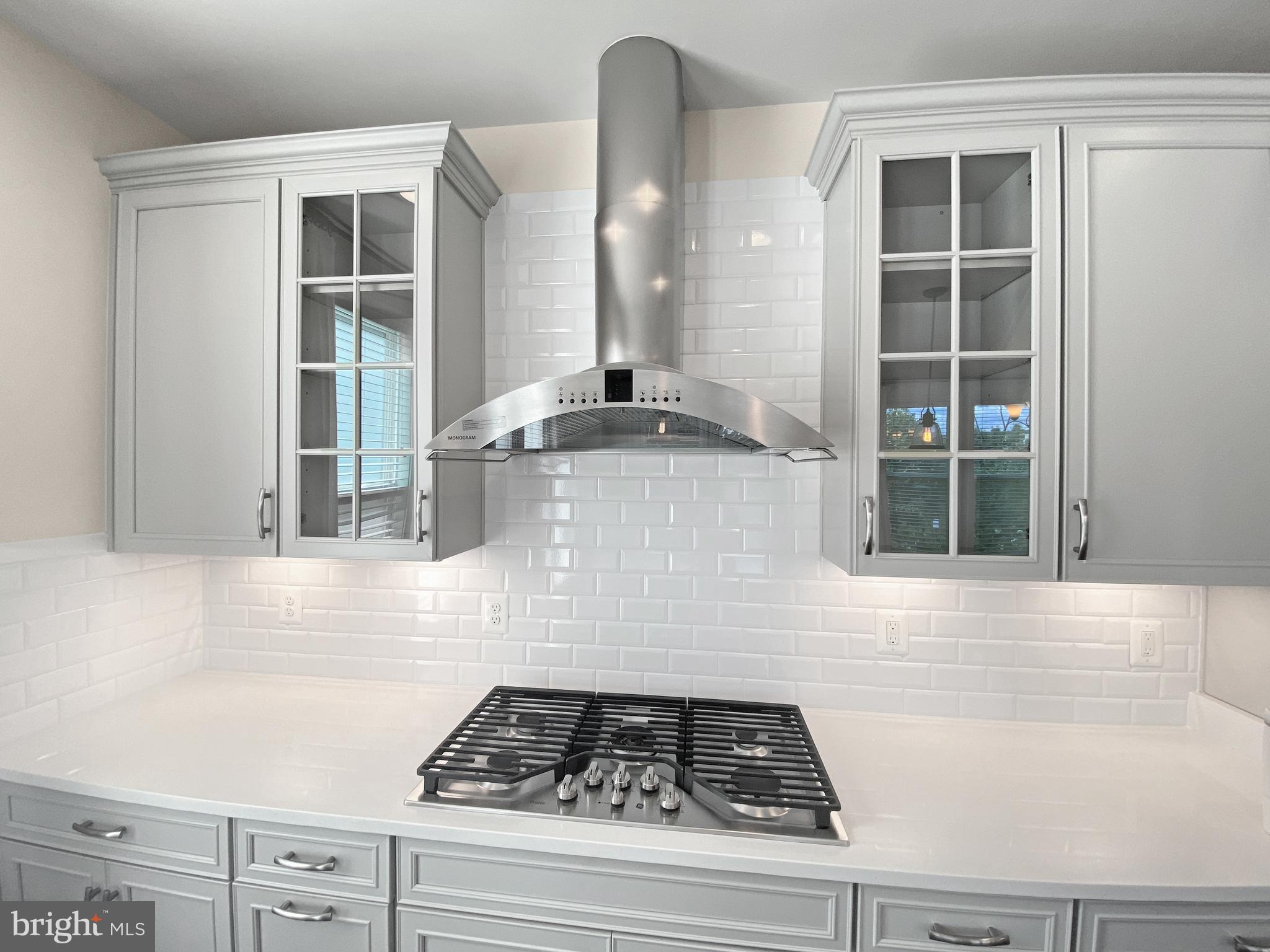4967 Lakeside Crossing Chantilly, VA 20151 - Photo 21 of 45 a kitchen with a stove and white cabinets