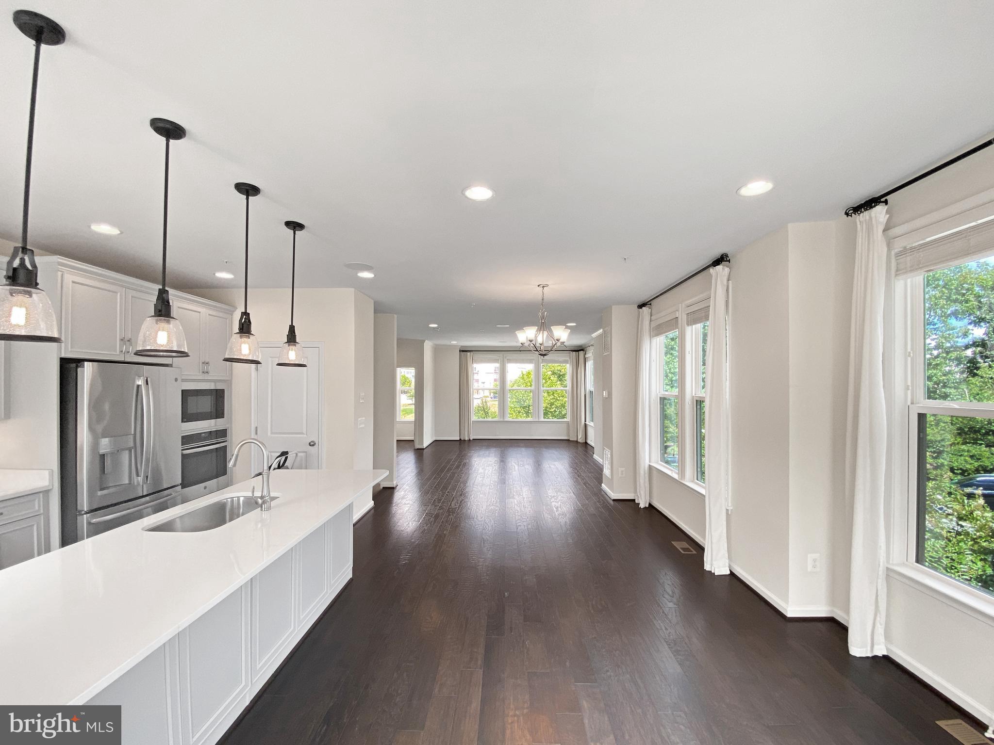 4967 Lakeside Crossing Chantilly, VA 20151 - Photo 45 of 45 a large living room with hardwood floor and a view of kitchen
