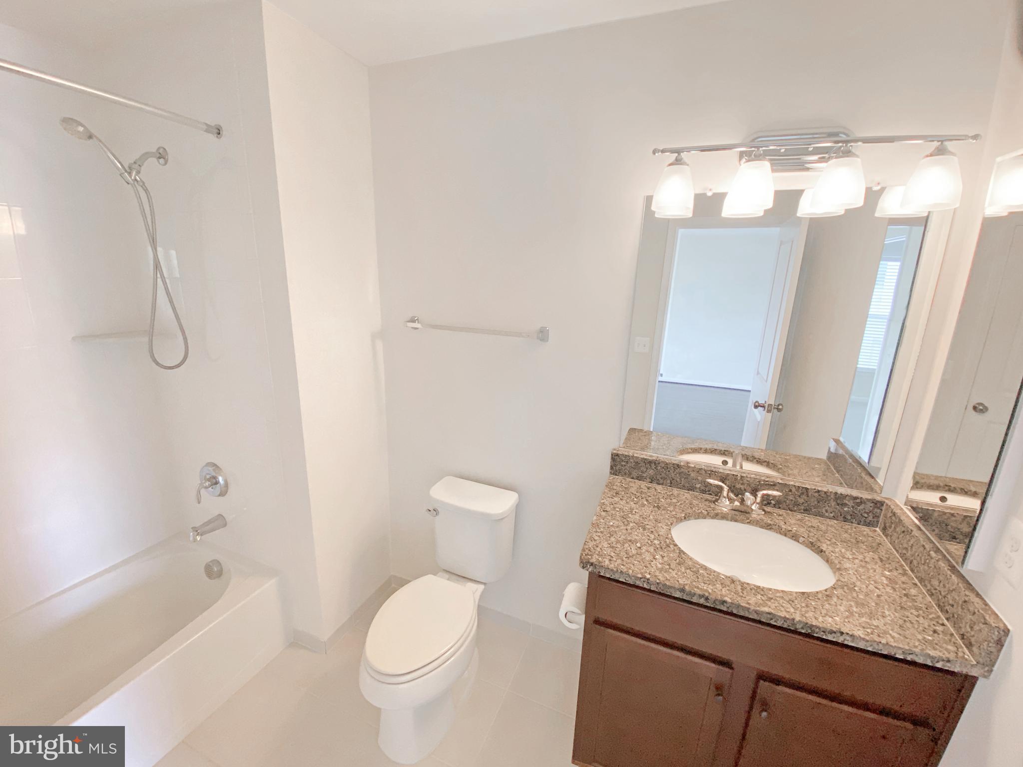 4967 Lakeside Crossing Chantilly, VA 20151 - Photo 36 of 45 a bathroom with a granite countertop sink toilet and shower
