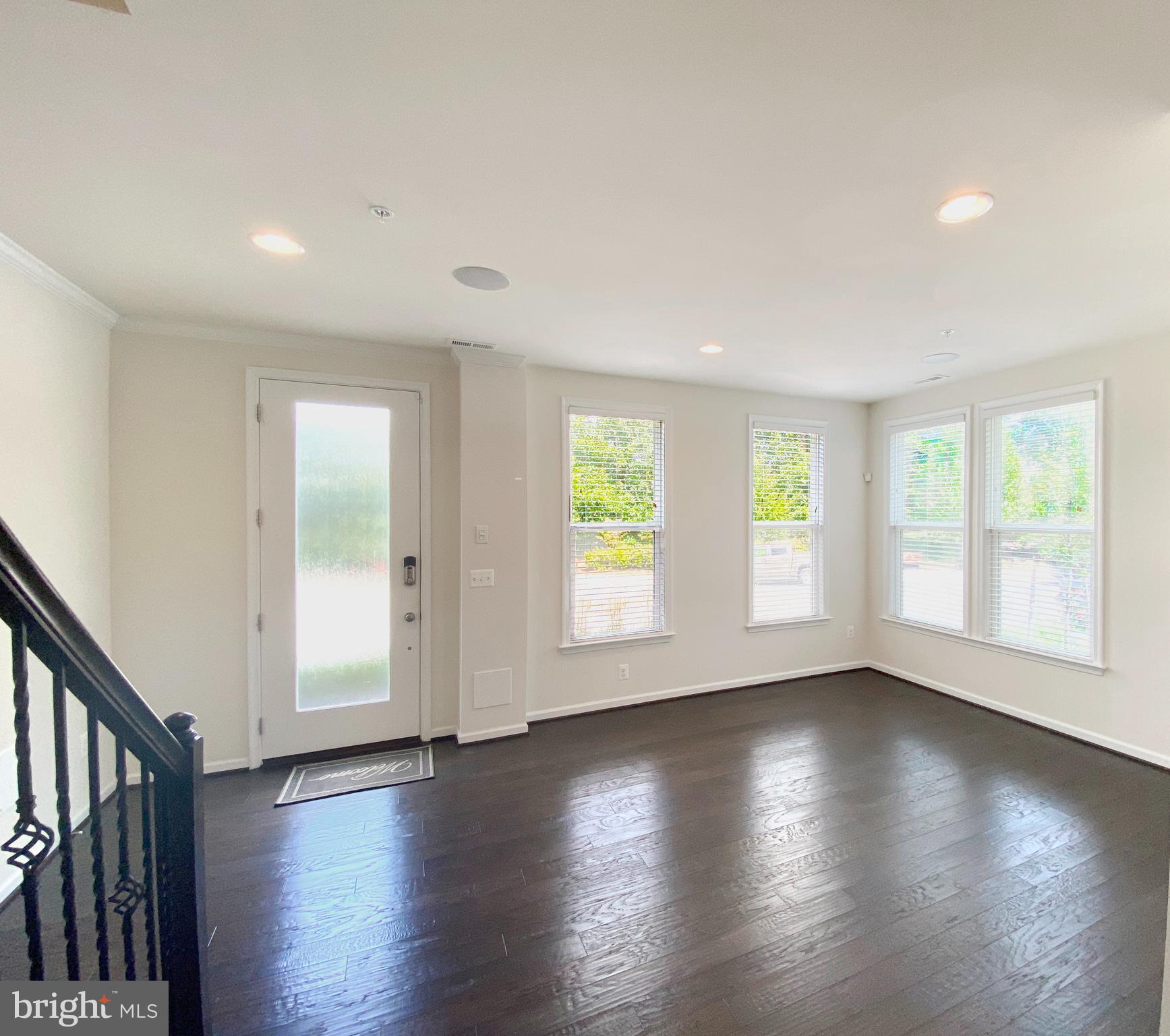 4967 Lakeside Crossing Chantilly, VA 20151 - Photo 37 of 45 an empty room with wooden floor and windows with curtains view