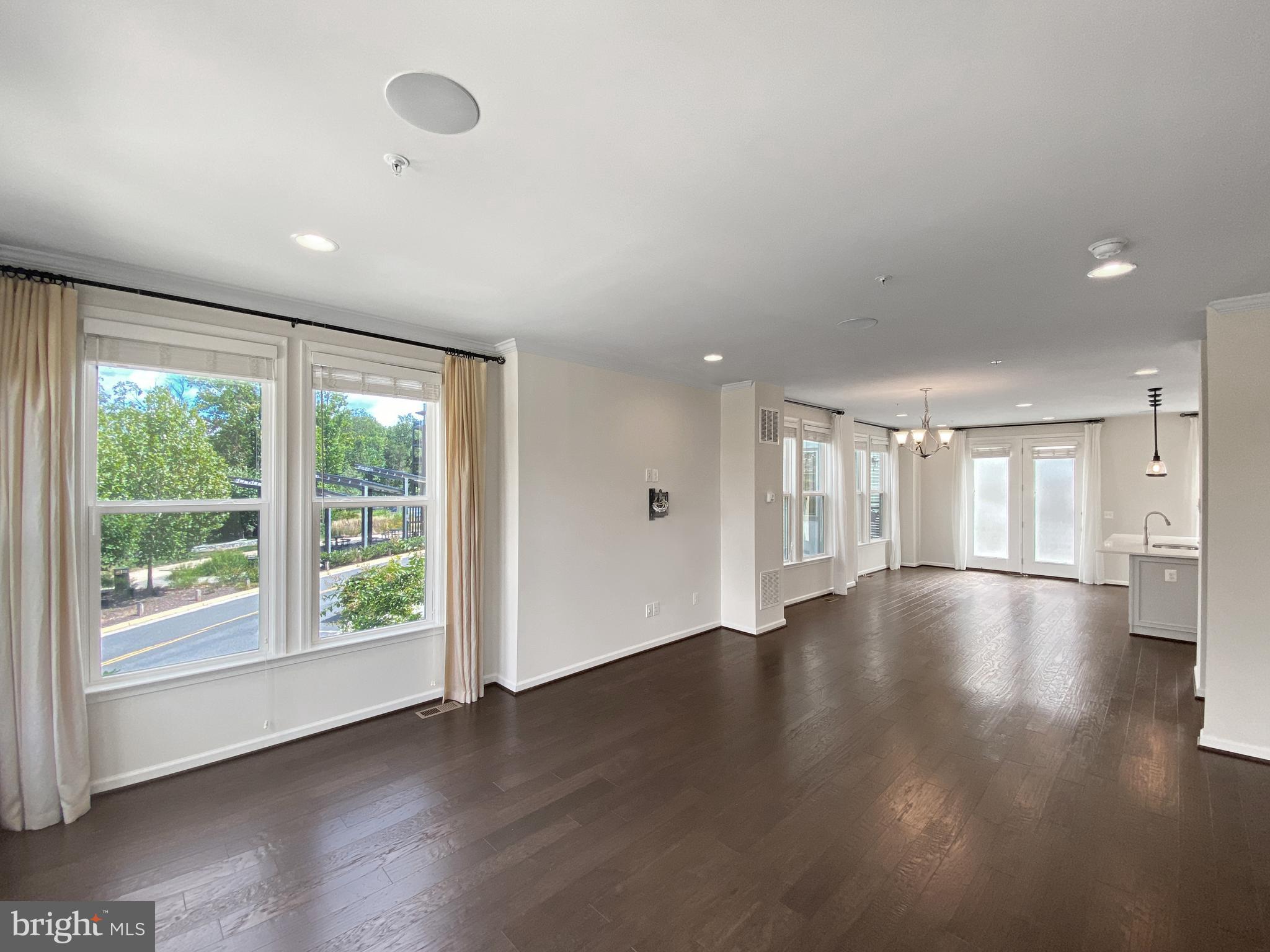 4967 Lakeside Crossing Chantilly, VA 20151 - Photo 3 of 45 a view of an empty room with wooden floor and a window