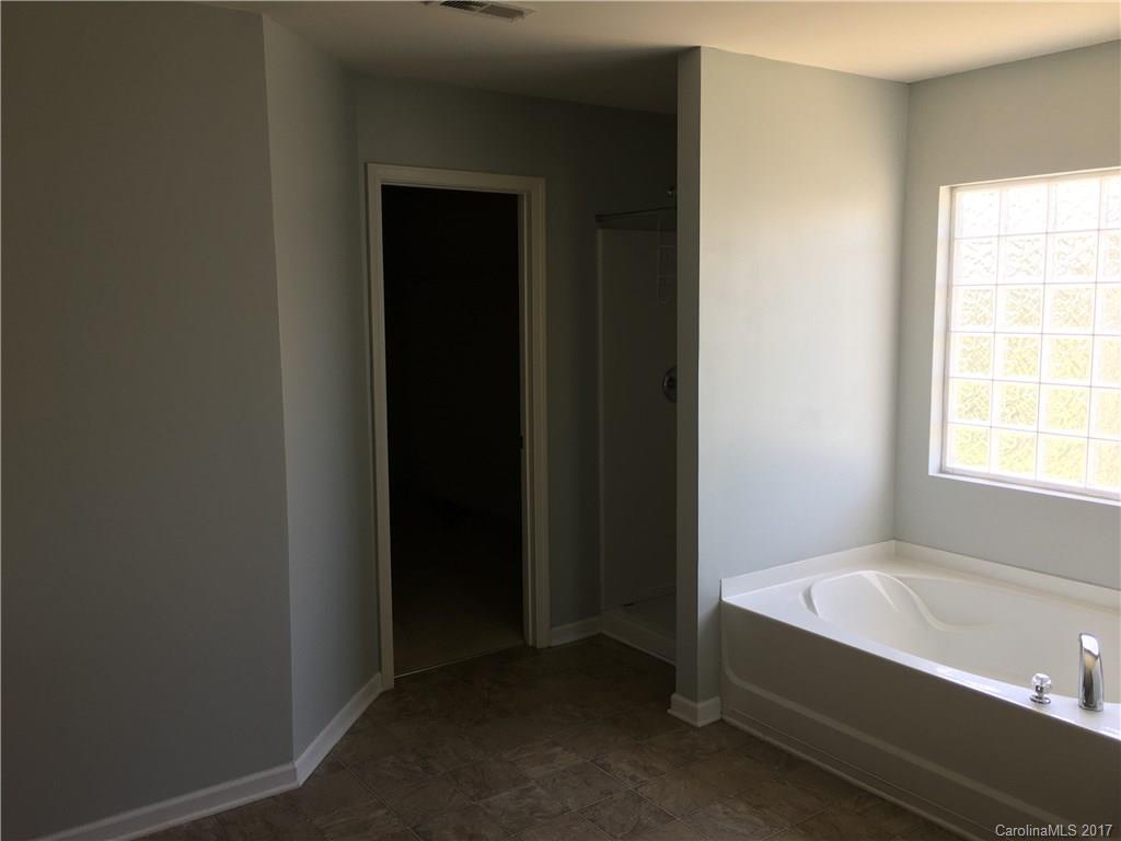 1011 Rural Farm Road Indian Trail, NC 28079 - Photo 14 of 24 a bathroom with a bathtub and a shower