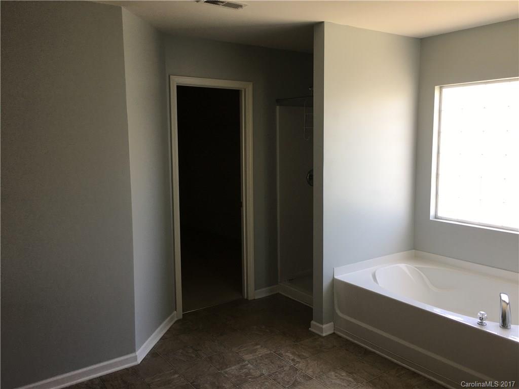 1011 Rural Farm Road Indian Trail, NC 28079 - Photo 16 of 24 a bathroom with a tub and shower