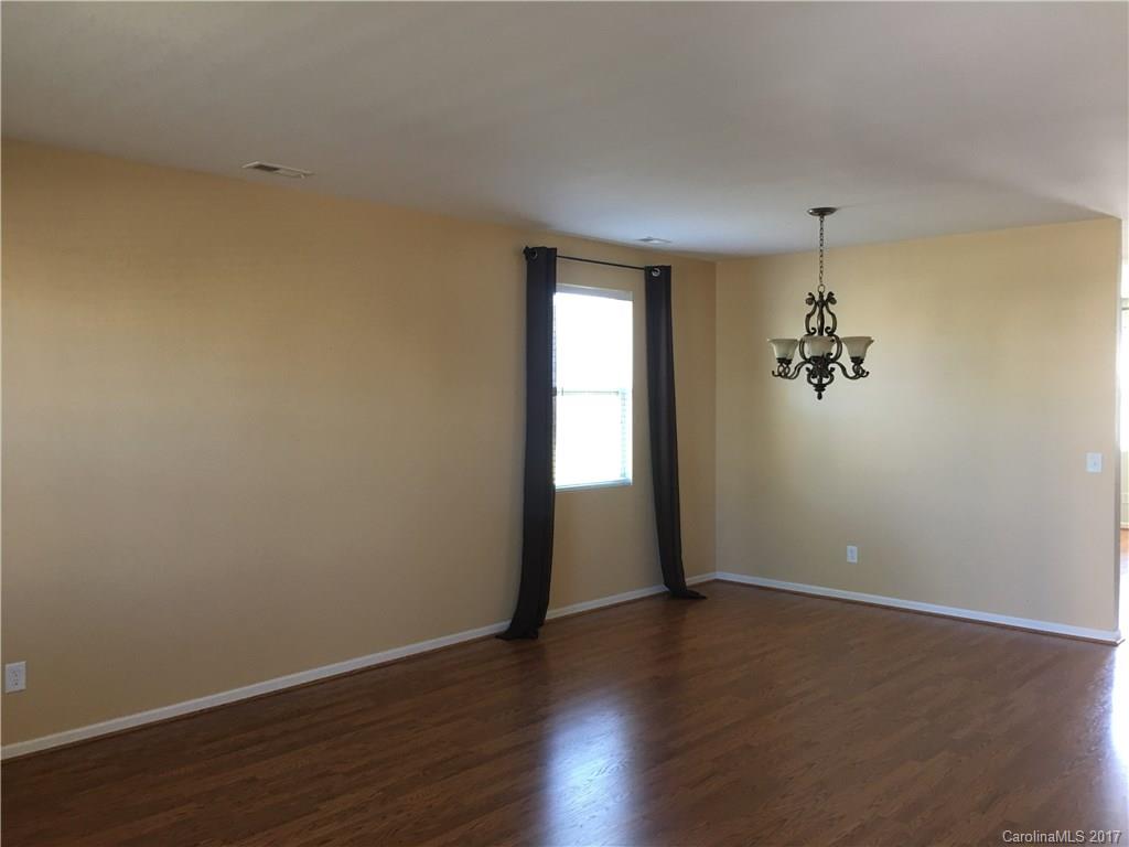 1011 Rural Farm Road Indian Trail, NC 28079 - Photo 3 of 24 an empty room with wooden floor and windows