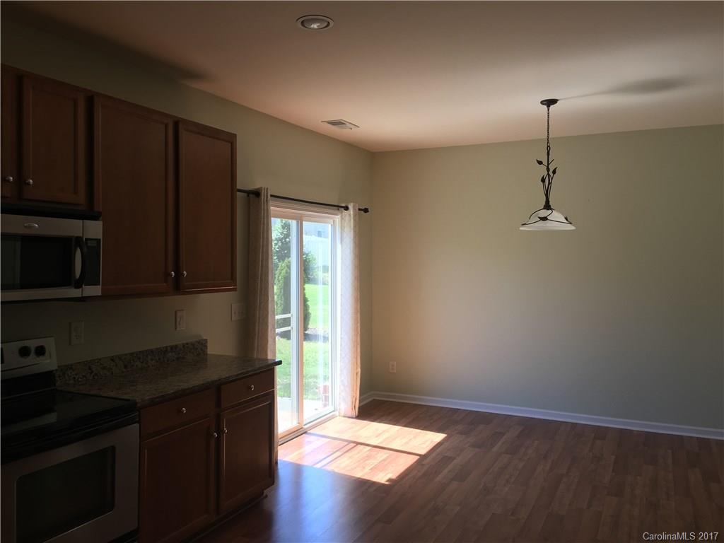 1011 Rural Farm Road Indian Trail, NC 28079 - Photo 7 of 24 a kitchen with a refrigerator and a stove top oven