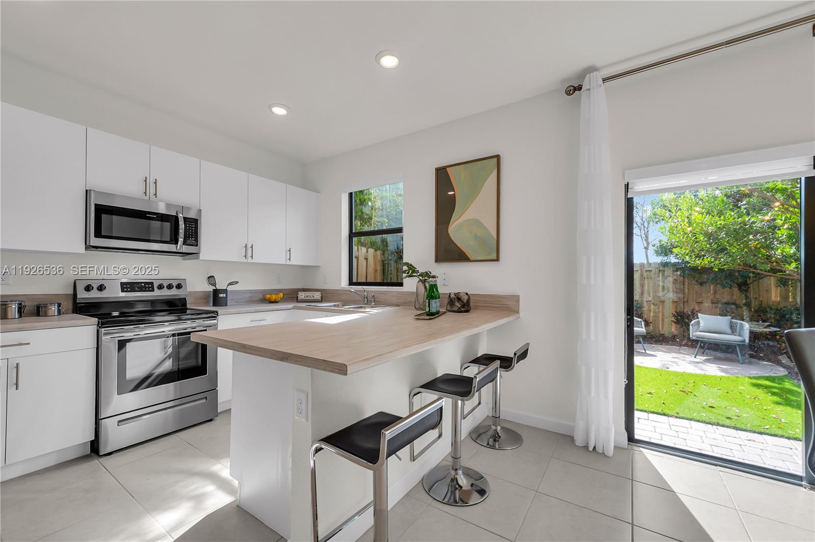 12980 Southwest 233rd Terrace Homestead, FL 33032 - Photo 11 of 28 a kitchen that has a sink and a stove top oven