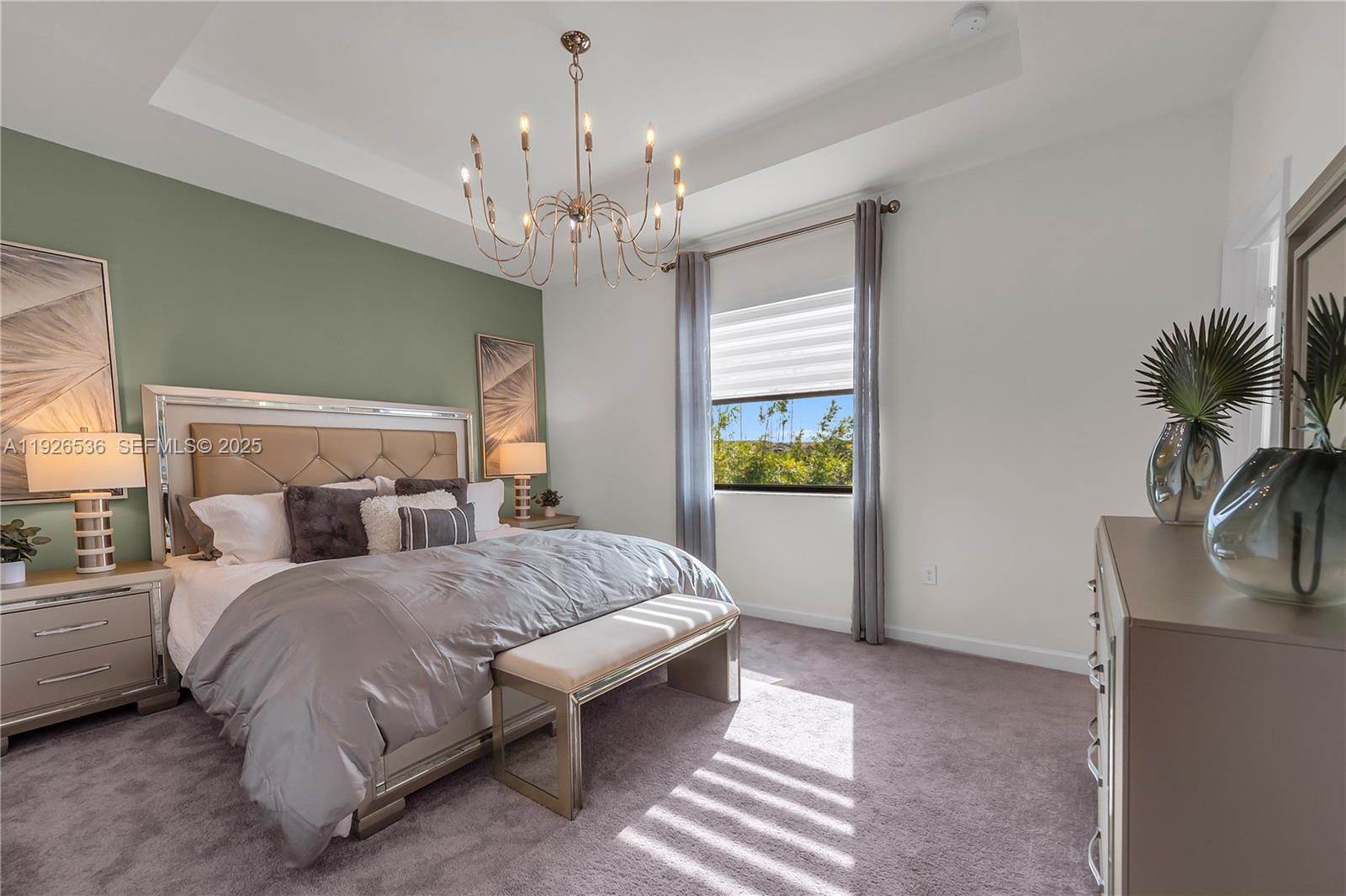 12980 Southwest 233rd Terrace Homestead, FL 33032 - Photo 17 of 28 a bedroom with a large bed and a chandelier